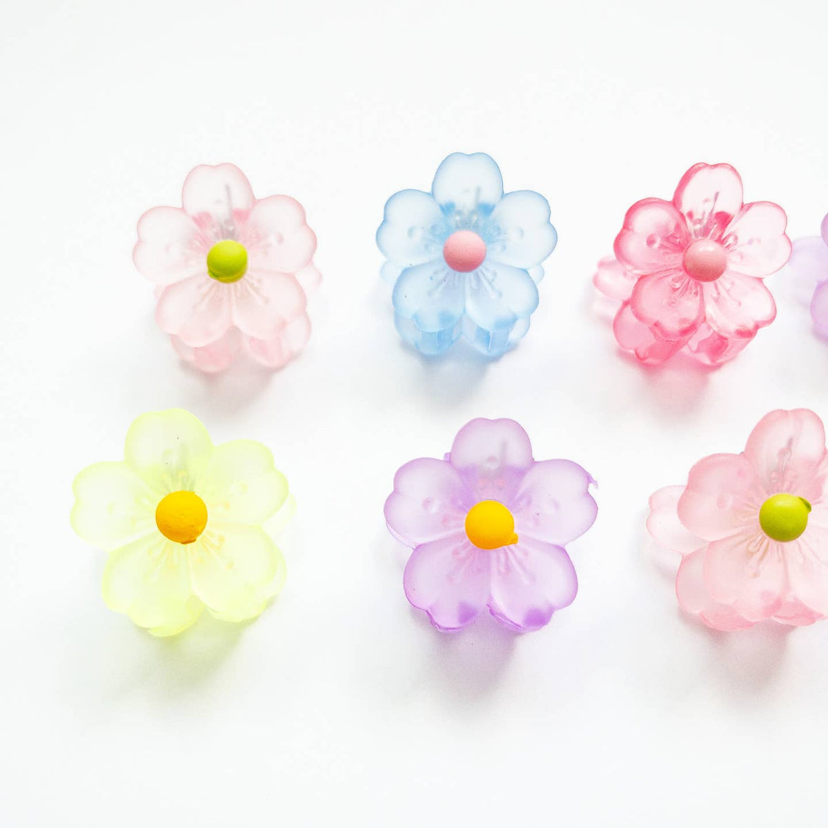 Pastel-colored flower-shaped objects on a white background