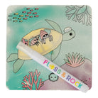 Children's book with a turtle illustration and a pen, featuring the brand 'Floss & Rock'.