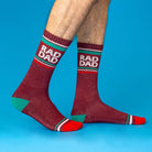 Maroon socks with 'RAD DAD' text on a blue background