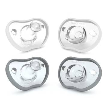 Four gray pacifiers on a white background