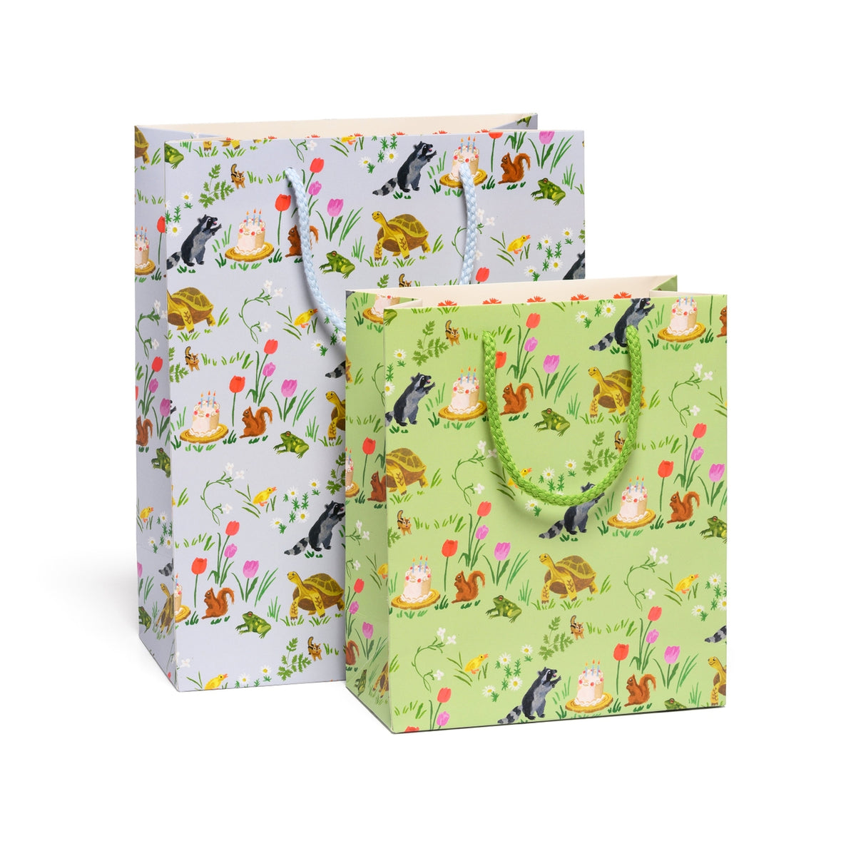 Two gift bags with animal and nature-themed designs on a white background
