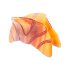 Orange and pink marbled object on a white background