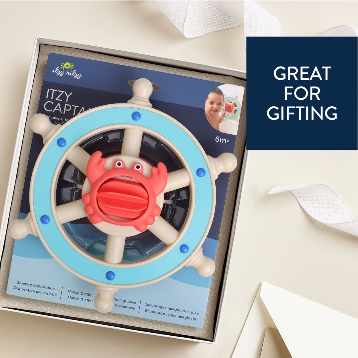 Toy steering wheel with red center and blue rim in packaging, labeled 'Itzy Capta', on a white background.