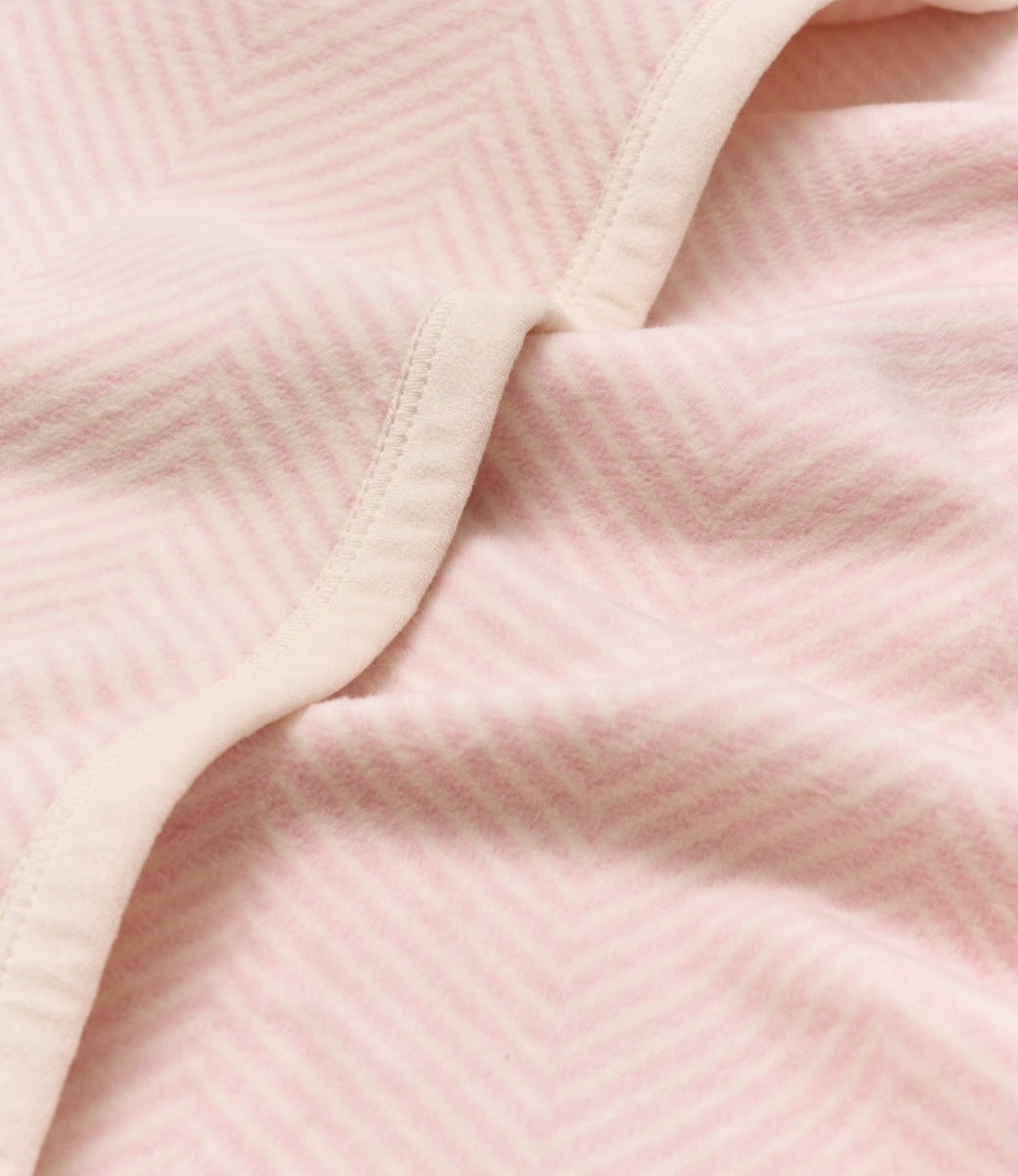 Close-up of pink fabric with a subtle pattern