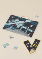 Space-themed gift bag with puzzle pieces and packaging on a beige background