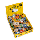 Peanuts button box with various buttons displayed on a white background