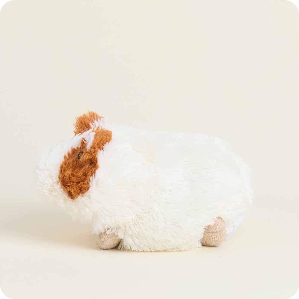 Plush toy resembling a dog with brown and white fur on a light background