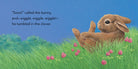Illustration of a bunny tumbled in clover with text on a blue background