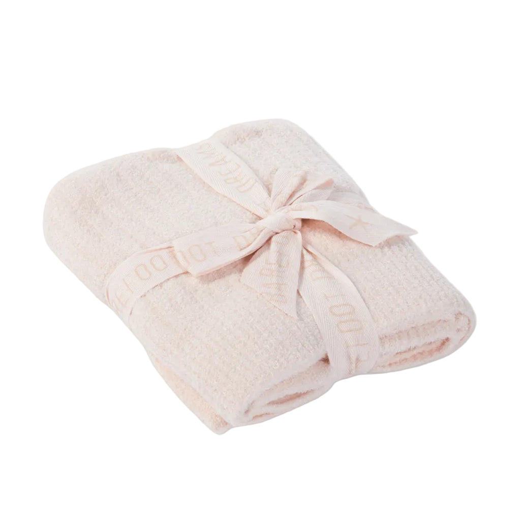 Pink towel with a knot on a light beige background