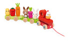 A colorful wooden toy train with animal and vegetable characters on a white background. The train has a red engine pulling green cargo cars carrying a yellow bean, red pepper, orange carrot, brown rabbit, pink radish, and white bunny, with a small orange chick on the front.