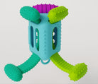 Möbi kNüdLL sensory activity toy, featuring a central light blue textured cube with three dangling textured rubber limbs in purple, lime green, and teal.
