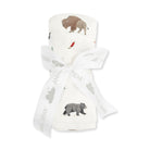 A folded white baby blanket with a printed woodland pattern of a bison, bear, and a small red bird, tied with a white ribbon printed with the Angel Dear brand name.