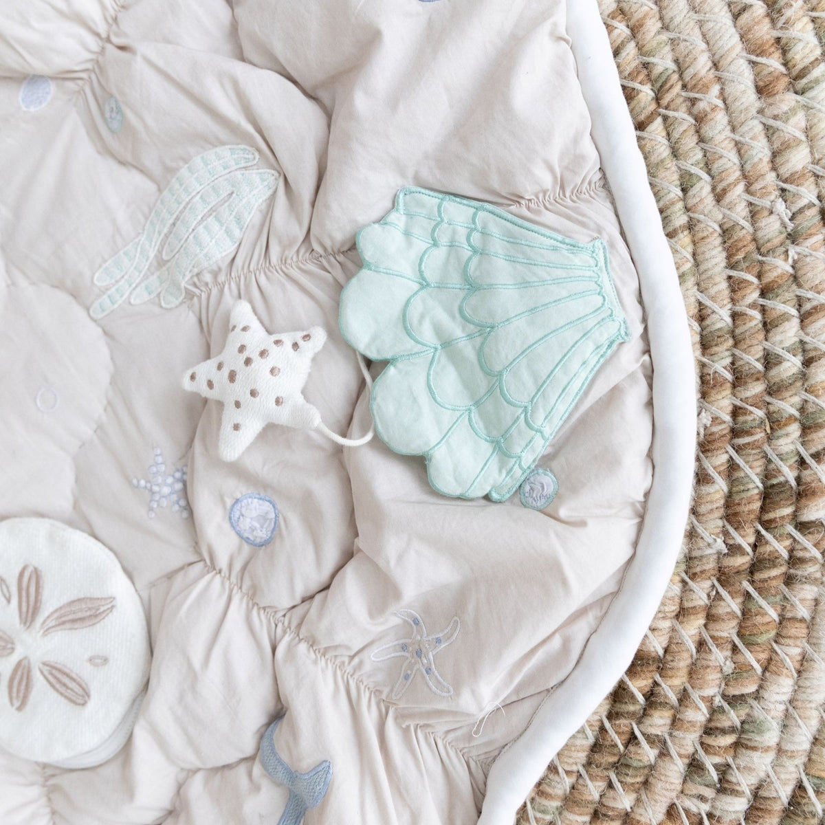 Baby outfit with sea-themed accessories on a textured surface