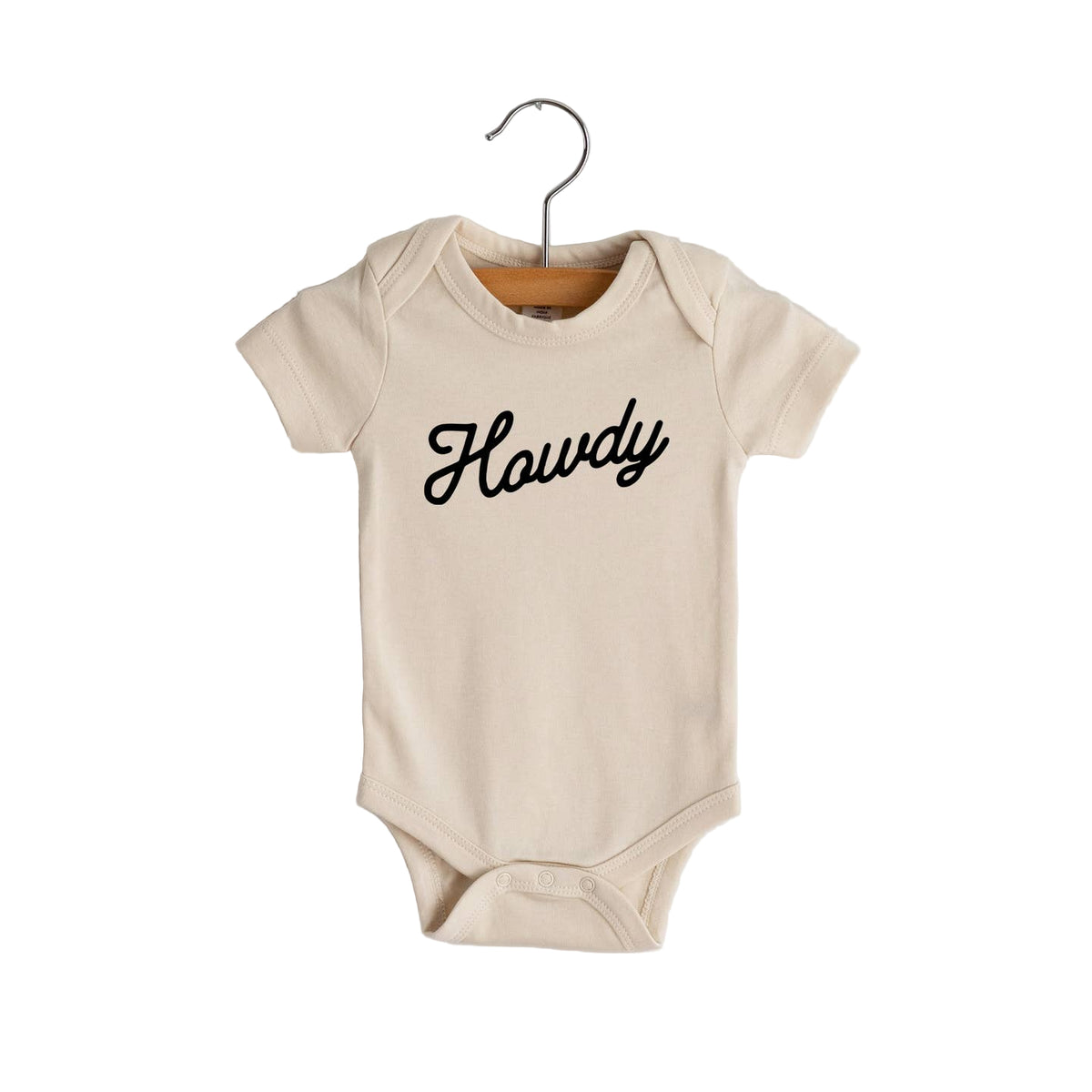 Beige baby onesie with 'Howdy' text on a hanger against a white background