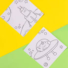 Two coloring sheets with space-themed designs on a yellow and green background