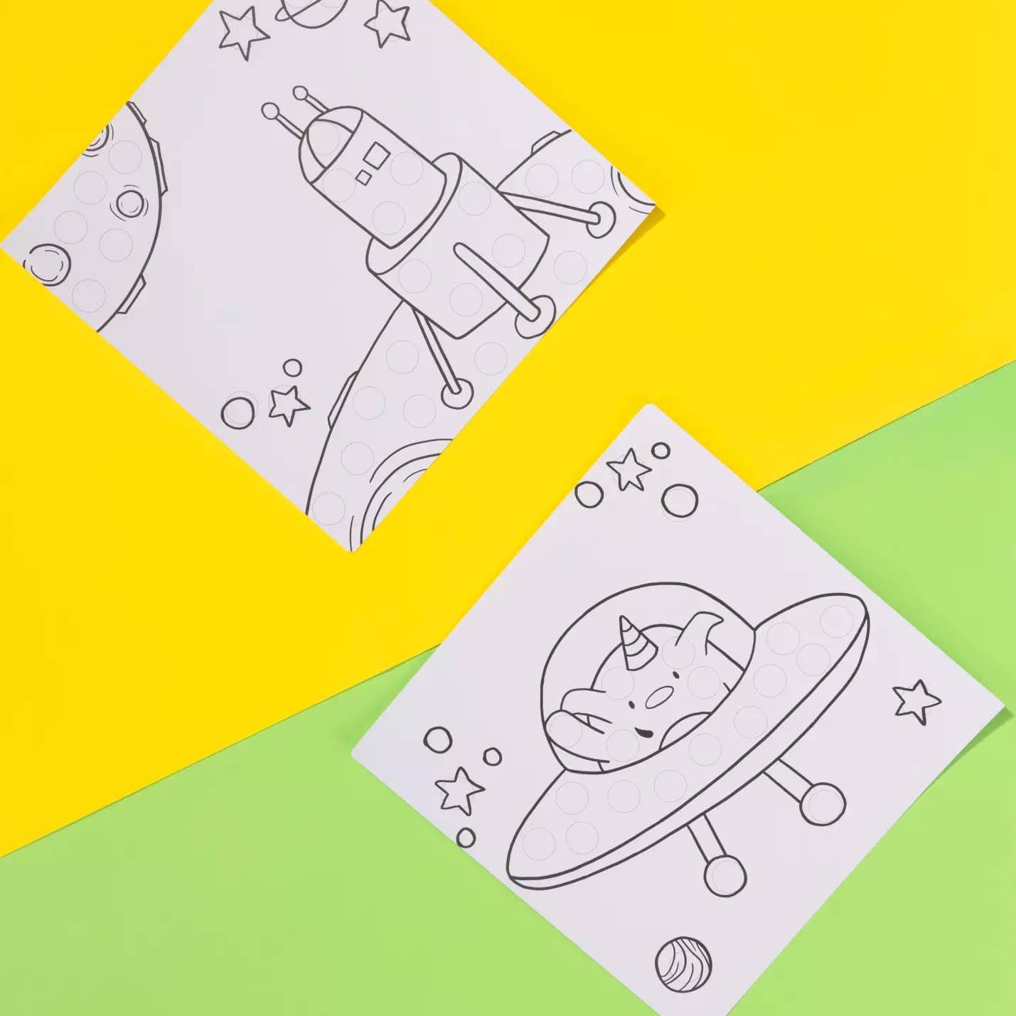 Two coloring sheets with space-themed designs on a yellow and green background