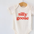 Baby onesie with 'silly goose' text on a white background