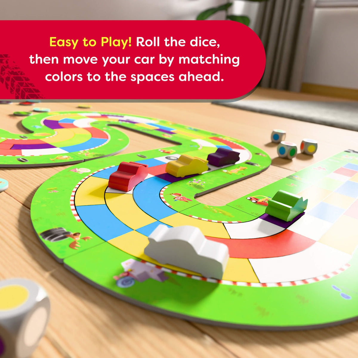 Children's board game with colorful track and dice on a wooden table