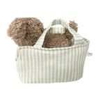 Striped fabric basket with a fluffy brown toy on a white background