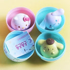 Four colorful containers with cute animal-shaped toys on a yellow background