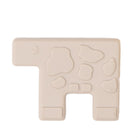 Beige silicone teether with various shapes on a white background