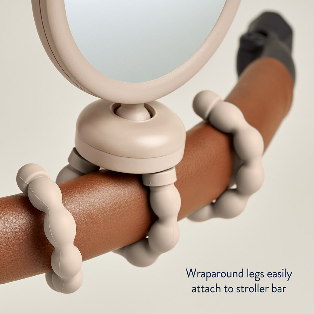 Beige wraparound leg attached to a stroller bar with a neutral background
