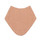 A peach-colored textured muslin baby bib with a subtle grid pattern, shown flat against a solid white background.