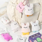 Plush keychains shaped like cartoon characters on a light background
