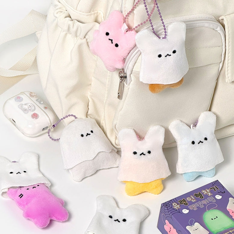 Plush keychains shaped like cartoon characters on a light background