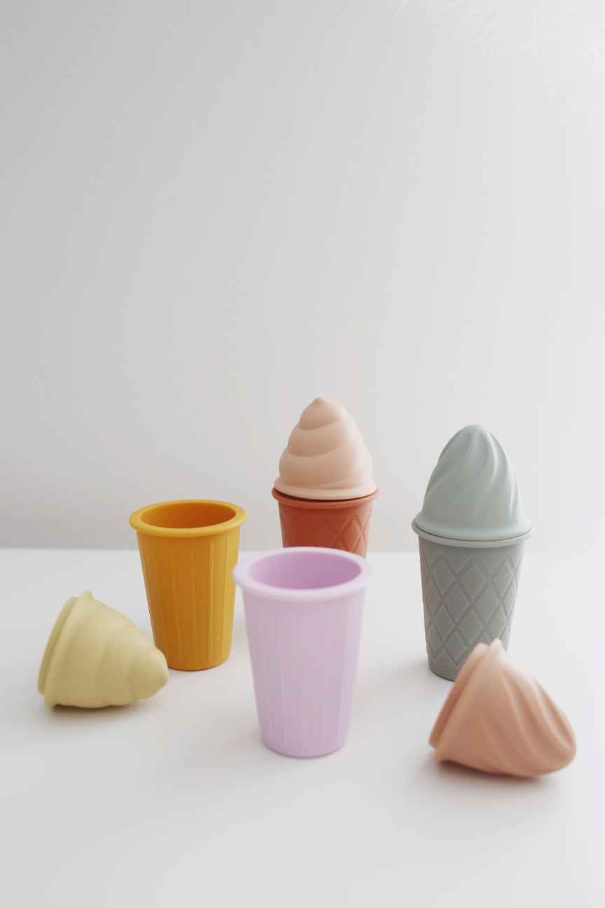 Set of colorful ceramic ice cream cones on a white background