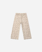 A pair of wide-leg cropped pants featuring an all-over beige and brown leopard print pattern on a cream background.
