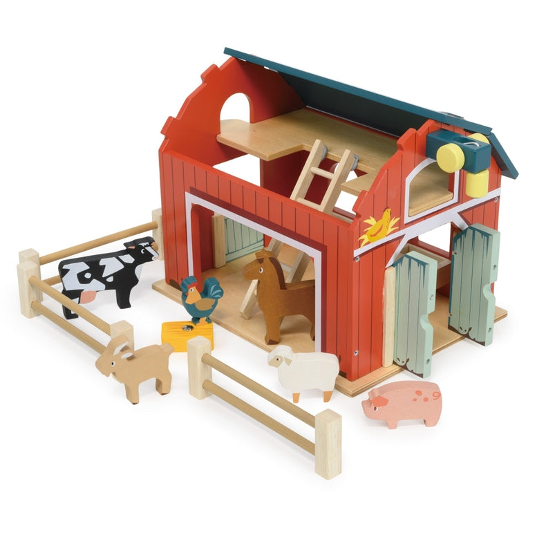 Wooden Big Red Barn Playset by Mentari set against a clean white background, showcasing the complete set including the two-story red and green barn, opening double doors, a working pulley system with a yellow magnetic hay bale, wooden fence sections, a blue ladder, and small wooden animal figures including a cow, horse, pig, sheep, goat, chicken, and rooster.