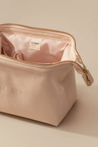 Beige cosmetic bag with 'MAMA' and 'Le Labo' branding on a beige background