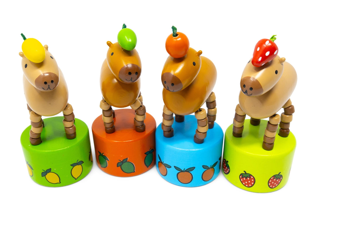 Set of four wooden horse toys with fruit on their heads and colorful bases.
