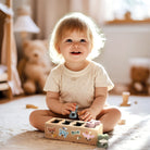 Child playing with a shape sorting toy in a cozy room