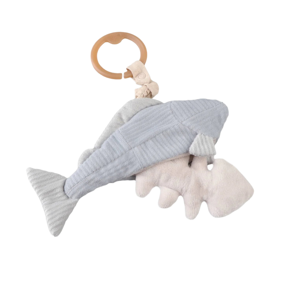 A plush trout baby rattle with a fishbone detail inside its belly, attached to a wooden ring at the top for hanging.
