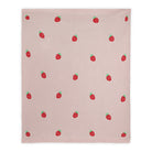 Pink blanket with red strawberry pattern on a white background