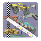 Children's notebook with monster truck illustrations and a pen on a white background