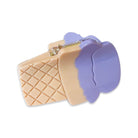 Ice cream cone-shaped cookie cutter with purple top on a white background