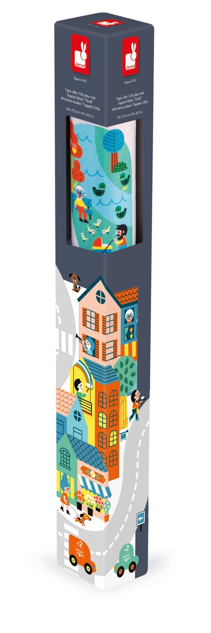 A tall, narrow retail display stand or poster featuring a colorful illustrated city street scene with houses, cars, pedestrians, and a map window near the top, shown on a plain white background.