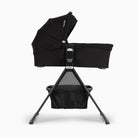 Black baby bassinet with canopy on a white background