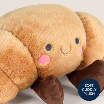 Plush toy resembling a bear with a smiling face on a light gray background