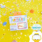 Sensory play product packaging with colorful confetti on a yellow background