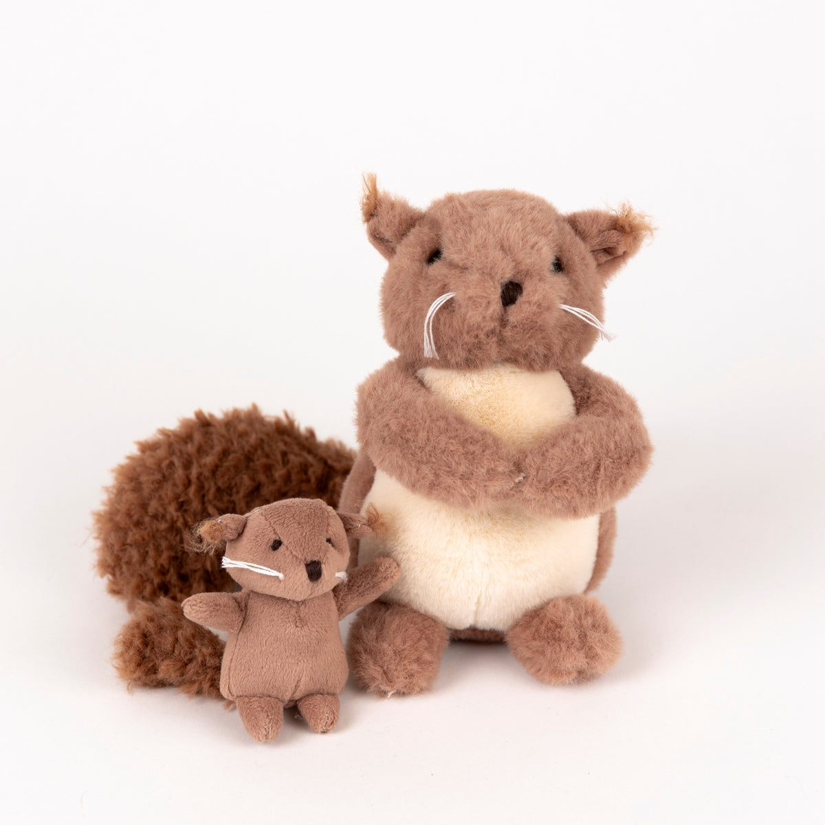 Two plush squirrel toys on a white background