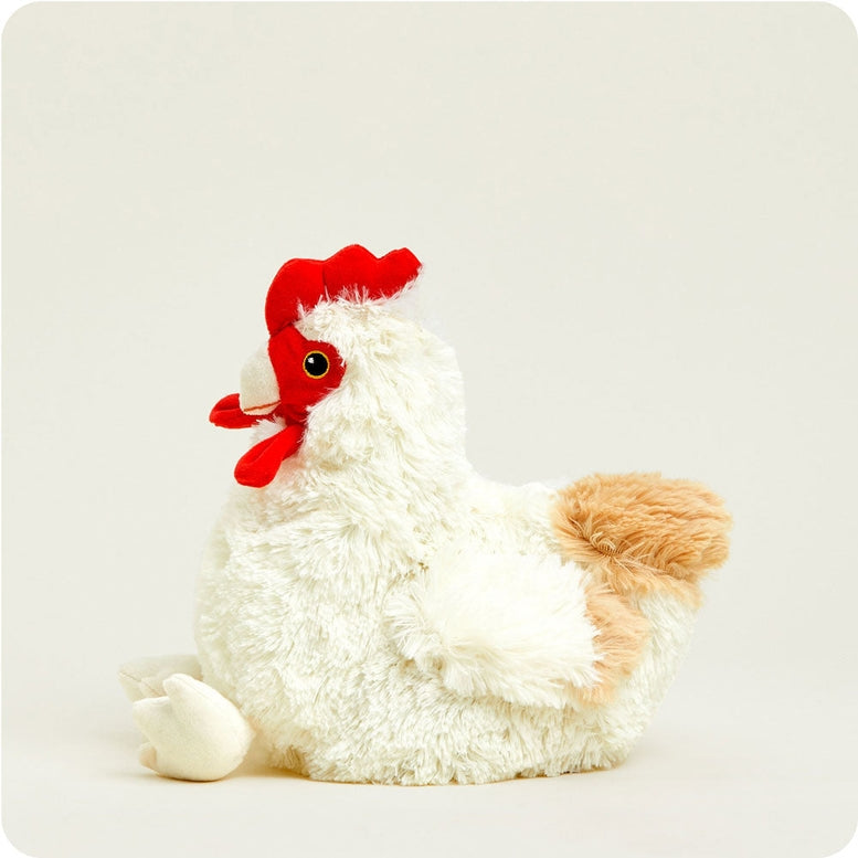 A white plush chicken toy with a bright red comb and wattle, sitting down against a neutral background.