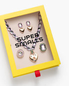 Jewelry set with necklace and earrings in a 'Super Smalls' box on a white background