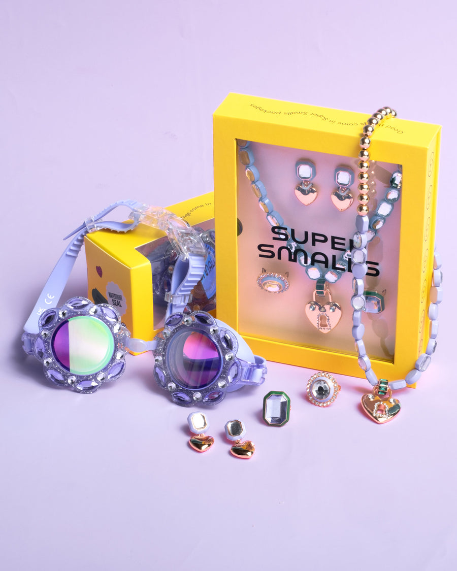 Colorful jewelry set with a yellow box on a light purple background