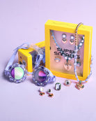 Colorful jewelry set with a yellow box on a light purple background