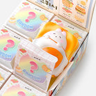 Squishy toy with packaging featuring colorful designs and text