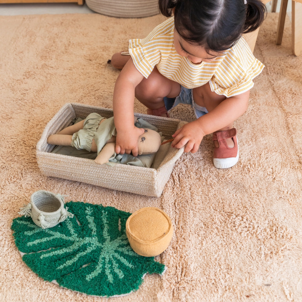 Child playing with toys on a carpeted floor